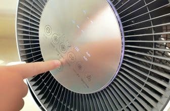 Child pushing button on room air purifier. Children using technology that improves quality of life