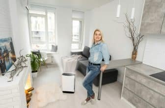 woman and air purifier at home. air humidification.